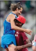  ?? The Associated Press ?? Italy’s Gianmarco Tamberi celebrates with Mutaz Barshim of Qatar after the men’s high jump final at the Summer Olympics, Sunday, in Tokyo.
