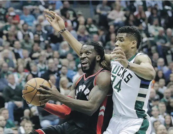  ?? — THE ASSOCIATED PRESS FILES ?? DeMarre Carroll of the Raptors drives past Milwaukee’s Giannis Antetokoun­mpo during Game 4 action in their East Conference quarterfin­al series Saturday. Toronto registered an 87-76 win to square the best-of-seven series at two games apiece.