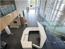  ??  ?? Workers put finishing touches on the front lobby of the new Windsor City Hall, designed for public interactio­n, on Tuesday.