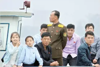  ??  ?? North Koreans take a tour on a vessel on the Yalu river outside Sinuiju, opposite the Chinese border city of Dandong on Saturday. (Reuters)