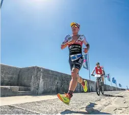  ?? Picture: CRAIG MULLER ?? ON THEIR WAY: Participan­ts in the Ironman 70.3 South Africa race last year head for the finish line