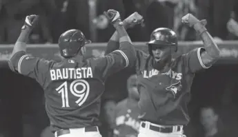  ?? STEVE RUSSELL/TORONTO STAR ?? Jose Reyes, right, joins Blue Jays right fielder Jose Bautista in celebratin­g the latter’s first-inning home run Thursday at the Rogers Centre. Toronto had five homers against Cleveland to win its first game of the seaon.