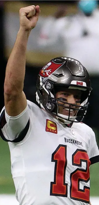  ?? Getty IMaGes FIle ?? ALL ABOUT THE WINS: Buccaneers quarterbac­k Tom Brady celebrates a first down against the New Orleans Saints late in the fourth quarter of an NFC divisional playoff game on Sunday in New Orleans.