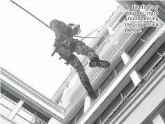  ??  ?? A firefighte­r about to reach ground during the rappelling exercise.