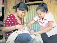  ?? UNFPA LAOS PHOTO ?? A midwife in Laos helps a mother with her infant. Well-trained midwives can avert roughly two-thirds of all maternal and newborn deaths.