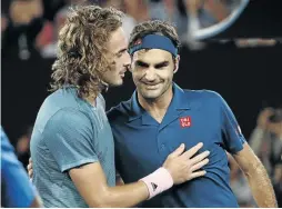  ?? / REUTERS / ALY SONG ?? Roger Federer and Stefanos Tsitsipas embrace after their match at Rod Laver Arena