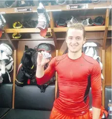  ?? BRUCE GARRIOCH ?? Senators rookie defenceman Max Lajoie holds the puck from his first NHL goal on Oct. 4. In town, Lajoie is staying at the home of veteran goaltender Craig Anderson.