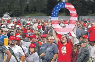  ?? Rick Loomis Getty Images ?? A PROPONENT of the QAnon conspiracy theory attends a President Trump rally in Wilkes-Barre, Pa., in 2018. Trump has retweeted accounts that promote the theory of a pedophile “deep state” working against him.