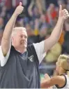  ?? STAFF PHOTO BY MATT HAMILTON ?? Bradley Central coach Jason Reuter gives two thumbs up to the student section and band after Friday’s Class 4A state semifinal win against Cookeville.