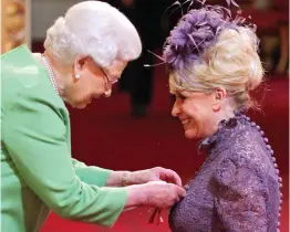  ??  ?? Honoured: The Queen makes Barbara a Dame in 2016