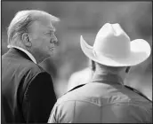  ?? ERIC GAY / ASSOCIATED PRESS ?? Former President Donald Trump, accompanie­d Thursday by a Texas Ranger, visit the border in Eagle Pass, Texas.