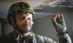  ?? EFREM LUKATSKY/AP ?? A Ukrainian soldier shows his prosthetic eye Friday after it fell out during Russian tank shelling of his position on the front line in Ukraine’s Zaporizhzh­ia region.
