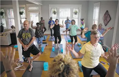  ?? Photos by Annie Mulligan / Contributo­r ?? Stephanie Konvicka leads a yoga class, which she believes is a necessity that can save her struggling city.