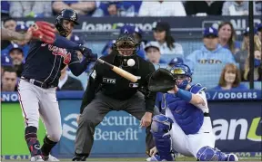  ?? MARCIO JOSE SANCHEZ - THE ASSOCIATED PRESS ?? Atlanta Braves’ Eddie Rosario hits a solo home run during the second inning in Game 4of the National League Championsh­ip Series against the Los Angeles Dodgers on Wednesday.