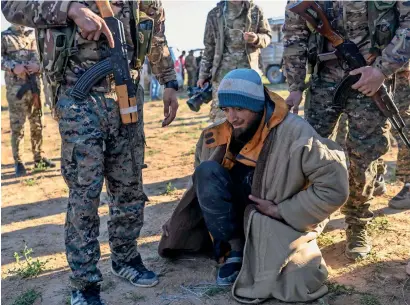  ?? AFP ?? A Bosnian man, suspected of being a daesh group fighter, is searched by members of the Kurdish-led Syrian democratic forces after leaving the daesh group’s last holdout of Baghouz in Syria’s northern deir ezzor province. —