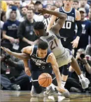  ?? JESSICA HILL — ASSOCIATED PRESS ?? Villanova’s Phil Booth, bottom, tangles with Connecticu­t’s Mamadou Diarra after pulling down a rebound during Saturday’s game in Hartford, Conn.