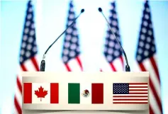  ?? — Reuters photo ?? The flags of Canada, Mexico and the US are seen on a lectern before a joint news conference on the closing of the seventh round of NAFTA talks in Mexico City, Mexico.