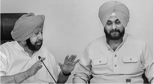  ??  ?? State Chief Minister Captain Amarinder Singh (left), Navjot Singh Sidhu meet to discuss rostering of ministers
