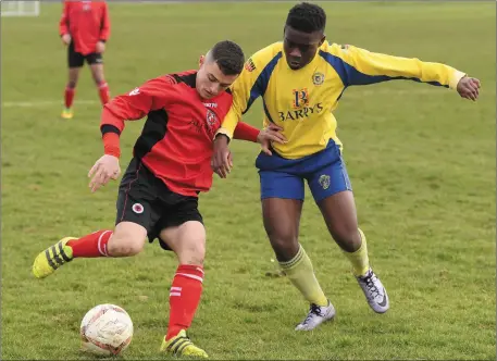  ?? Photo by Domnick Walsh ?? Leo Gaxha, Tralee Dynamos, (red) and Adam Kanza, Douglas Hall, in action in their FAI U-17 Cup at Mounthawk Park, Tralee last Sunday.