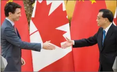  ?? AP PHOTO FRED DUFOUR ?? Prime Minister Justin Trudeau and Chinese Premier Li Keqiang prepare to shake hands at the end of a press conference in Beijing Monday.