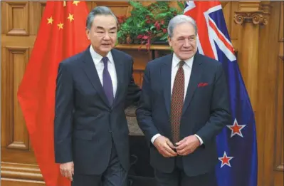  ?? HAGEN HOPKINS / POOL PHOTO VIA AP ?? Foreign Minister Wang Yi (left) meets with New Zealand Foreign Minister Winston Peters in Wellington, New Zealand, on Monday.