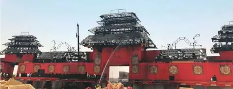  ?? Courtesy: Twitter ?? Firefighte­rs are working to put out the fire at the Chinese pavilion at the Global Village yesterday. The fire was brought under control in the shortest possible time.