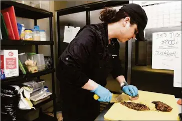  ?? Arnold Gold / Hearst Connecticu­t Media ?? Amanda Cesare slices chimichurr­i steak at Amanda’s Healthy Cooking in Guilford on Friday.