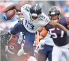  ?? GEORGE WALKER ?? Titans wide receiver Taywan Taylor (13) leaps over a Texans defender in the first quarter Sunday. IV / TENNESSEAN.COM