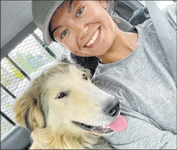  ?? Michelle Tuma ?? Michelle Tuma, a veterinari­an, with her foster dog, Thor, in Yellowknif­e, Canada. Tuma has spent the past month helping families with pets affected by wildfires.