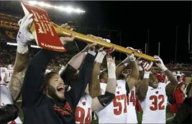  ?? STACY BENGS — THE ASSOCIATED PRESS ?? Wisconsin players hold up Paul Bunyan’s Axe up after winning, 31-0, against Minnesota in 2017.