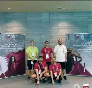  ??  ?? Qatar Olympic Committee (QOC) Secretary-General HE Jassim bin Rashid Al Buenain with Qatar athletes at the Team Qatar accommodat­ion at Olympic Village in Tokyo on Sunday.