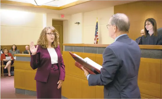 ?? JEN RYNDA/CAPITAL GAZETTE ?? Pamela Alban is sworn in as Anne Arundel County Circuit Court's newest judge by Robert Duckworth at Anne Arundel County Circuit Court on Thursday. She has served as the division chief for the Special Victims Unit and for the Sex Offense and Child Abuse Unit.