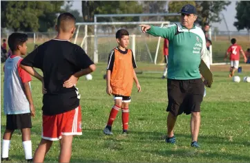  ?? RECORDER PHOTO BY CHIEKO HARA ?? Cesar Vega Perrone, a retired Uruguayan national soccer player works closely with South Valley Chivas players Wednesday at the Portervill­e Sports Complex. Vega, who coached Mexico’s youth national soccer team, travels internatio­nally to hold soccer clinics and scout young players.