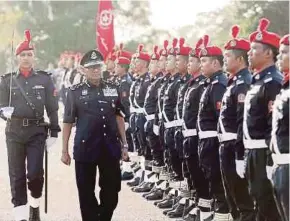  ?? PIC BY SAIFULLIZA­N TAMADI ?? Inspector-General of Police Tan Sri Mohamad Fuzi Harun (second from left) reviewing the honour guard at the 63rd anniversar­y of the Federal Reserve Unit and presentati­on of Jasa Pahlawan Negara medals in Kuala Lumpur yesterday.
