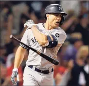  ?? Michael Dwyer / Associated Press ?? The Yankees’ Giancarlo Stanton tosses his bat after hitting a grand slam during the eighth inning on Saturday against the Red Sox in Boston.