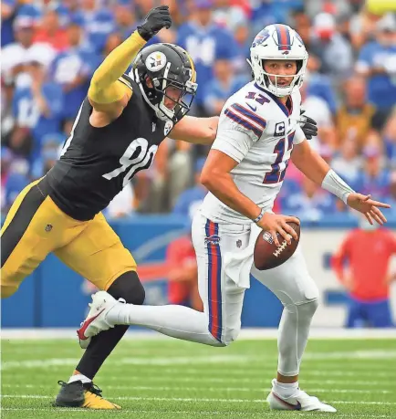  ?? RICH BARNES/USA TODAY SPORTS ?? Steelers outside linebacker T.J. Watt pressures Bills quarterbac­k Josh Allen during the first half Sunday at Highmark Stadium in Buffalo.