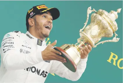  ?? Picture: Reuters ?? HOME SUCCESS. Mercedes’ Lewis Hamilton celebrates after winning the British Formula One Grand Prix at Silverston­e yesterday.