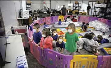  ?? Dario Lopez-Mills Associated Press ?? MIGRANT CHILDREN watch TV at a Customs and Border Protection facility Tuesday in Donna, Texas. The Long Beach Convention Center could soon be tapped to house kids apprehende­d at the border, a source says.