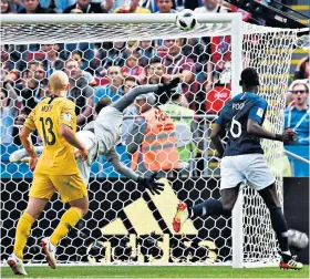  ??  ?? Touch of class: Paul Pogba sees his deflected shot provide France’s late winner