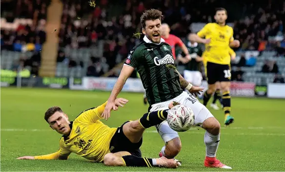  ?? PICTURE: SEAN HERNON/PPAUK ?? Plymouth Argyle’s Graham Carey is tackled by Oxford United’s Josh Ruffels (left) at Home Park on Saturday