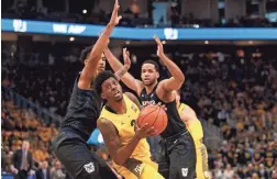  ?? JEFF HANISCH/USA TODAY SPORTS ?? Marquette guard Sacar Anim looks to shoot between Butler defenders Sunday in Milwaukee.