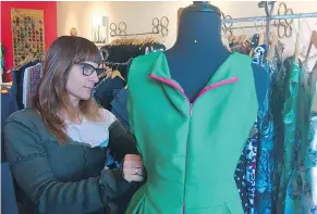  ?? — SOLVEJ SCHOU ?? Matrushka Constructi­on’s Laura Howe adjusts a long green dress that can be worn as an unconventi­onal wedding dress.