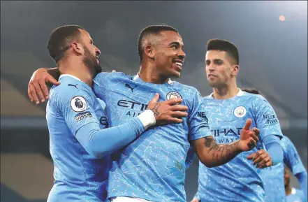  ?? REUTERS ?? Gabriel Jesus (center) celebrates scoring Manchester City’s second goal with Kyle Walker during Tuesday’s 4-1 English Premier League home win over Wolverhamp­ton Wanderers at Etihad Stadium.