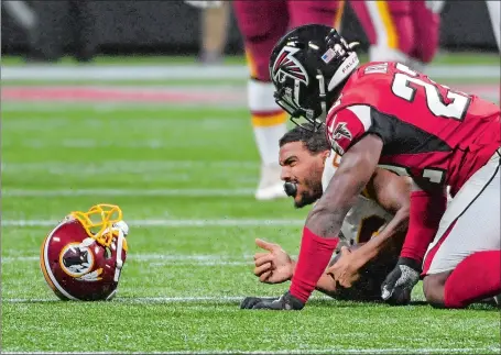  ?? JONATHAN NEWTON/WASHINGTON POST ?? Washington tight end Jordan Reed lost lost helmet and suffered a concussion on this hit by Atlanta strong safety Keanu Neal in the third exhibition game of the 2019 preseason. The ex-New London High great missed the entire 2019 regular season, but after spending the 2020 season with the San Francisco 49ers, Reed announced his retirement on Tuesday.