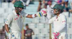  ??  ?? Mushfiqur Rahim (right) celebrates with Sabbir Rahman after scoring a half century. —