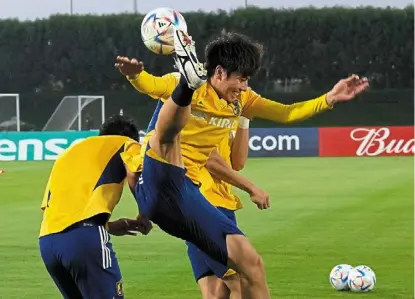  ?? — ap ?? High hopes: Japan players warm up during a training session ahead of their opening match against Germany.