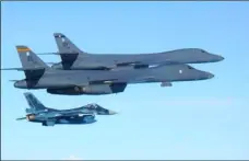  ?? AP PHOTO ?? In this photo released by Japan Air Self Defense Force, U.S. Air Force B-1B bombers (top) fly with a Japan Air Self Defense Force F-2 fighter jet over Japan’s southern island of Kyushu, just south of the Korean Peninsula, during a Japan-U.S. joint...