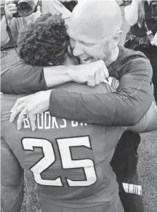  ?? TOMMY GILLIGAN/USA TODAY SPORTS ?? Defensive back Antoine Brooks Jr. celebrates with Matt Canada after Maryland upset Texas.