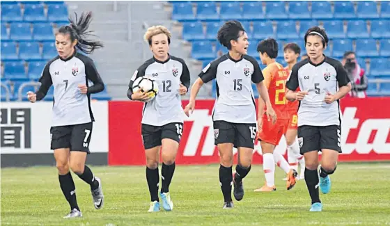  ??  ?? Rattikan Thongsombu­t, second left, celebrates with teammates after scoring against China in the third-place play-off at the AFC Women’s Asian Cup.