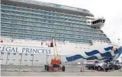  ?? CARLINE JEAN/SOUTH FLORIDA SUN SENTINEL ?? A worker disinfects a balcony Tuesday, top, on board the Regal Princess docked in Port Everglades in Fort Lauderdale.